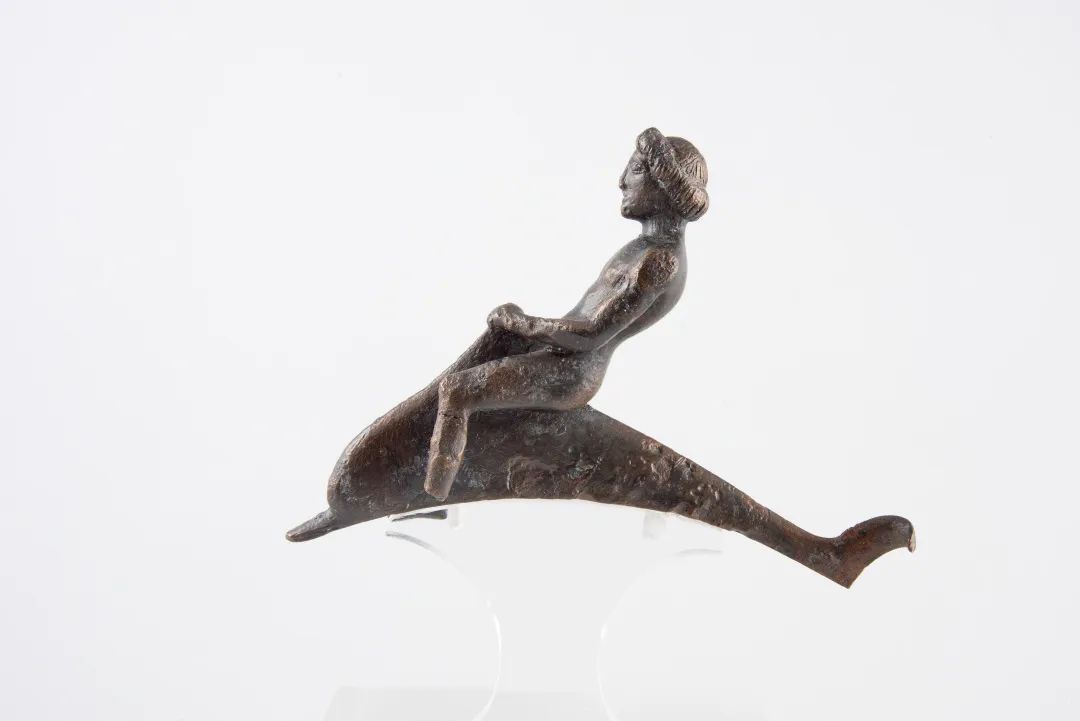A young man riding a dolphin, 475-450 BC, bronze, 7.5 cm high, 10.5 cm long, excavated from the Acropolis, in the collection of the Acropolis Museum