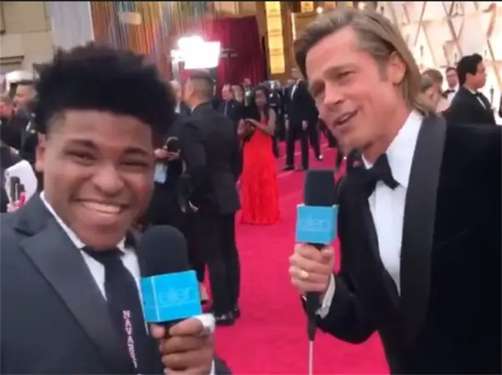 Jerry Harris, left, interviews Brad Pitt as a guest reporter on the 2020 Oscars red carpet.