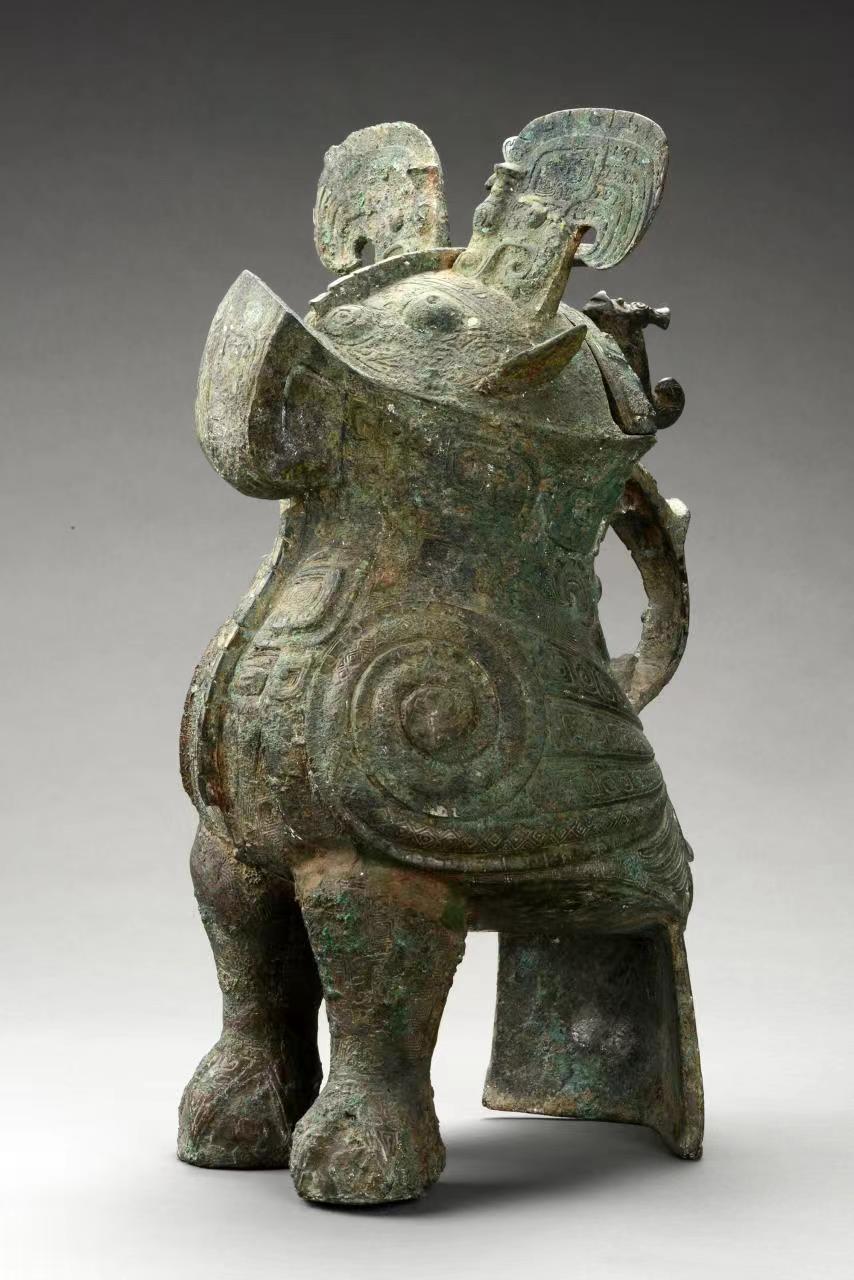 Fuhao Owl Respect Late Shang Dynasty (13th century BC - 1046 BC) height 45.9 cm, mouth length 16.4 cm, unearthed from Fuhao Tomb, Xiaotun, Anyang in 1976. The owl in the Henan Museum stands in a standing position, with its head held high, round eyes and wide mouth. Small ears, high crown, high chest and wings, thick legs, and broad tail for support. The owl's head has a semi-circular mouth at the back, with a cover on top. The owl's back is cast with a hawk, and the owl's jewelry is in the shape of a beast's head. There is a gate edge on the middle of the face and on the chest. The whole body is full of flowers, decorated with animal face patterns, Kui patterns and snake patterns. And so on, and with thunder pattern backing, the front of the cover has a pointed-billed standing bird, and a standing dragon with an arched body and a curly tail at the back. There are two inscriptions on the inner wall under the mouth of the vessel.